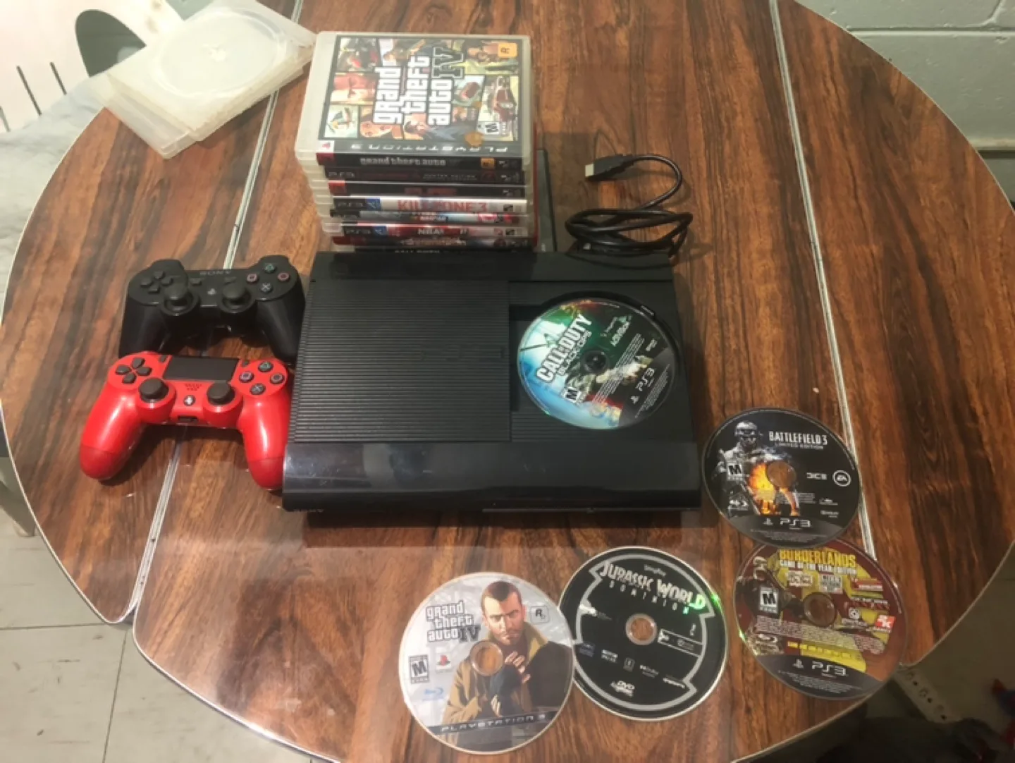 PlayStation 3 Console with Games and Controllers thumbnail