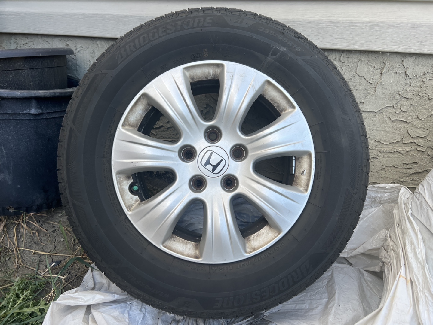 235/65R16 103T Bridgestone Tires including Original Rims.