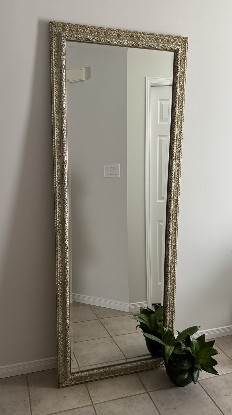 Large mirror with ornate decorative frame