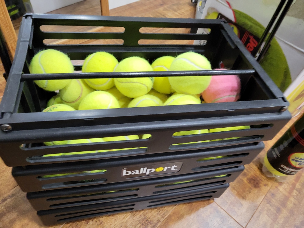 New Tennis Balls and portable tennis ball hopper