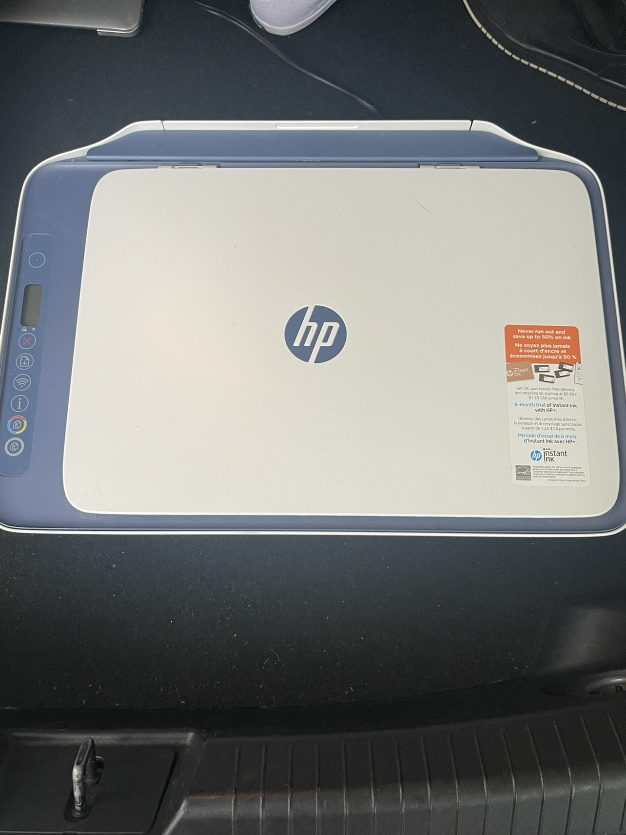 HP DeskJet 2742e All-in-One Printer, ink, and printer paper.