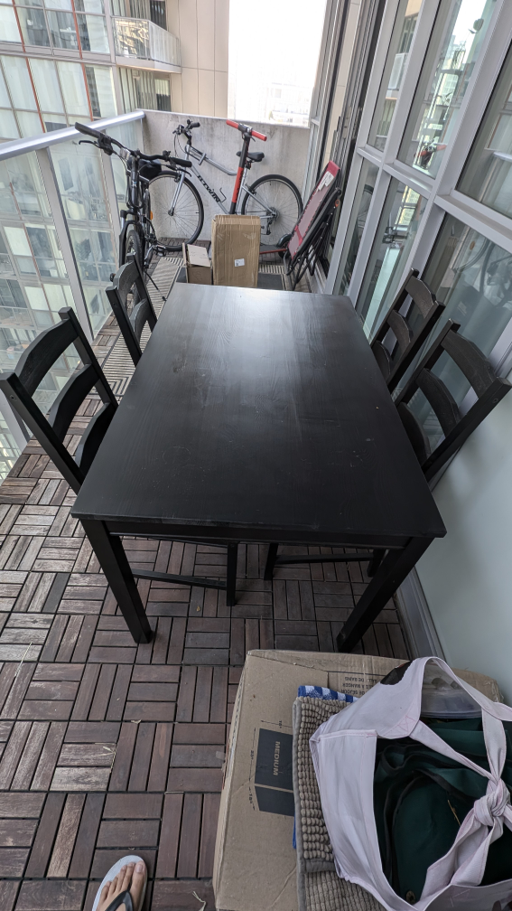 IKEA dining table with four chairs and cushions