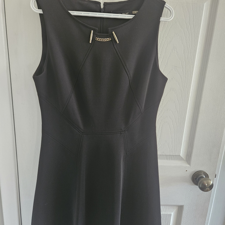 Black sleeveless dress with gold chain detail