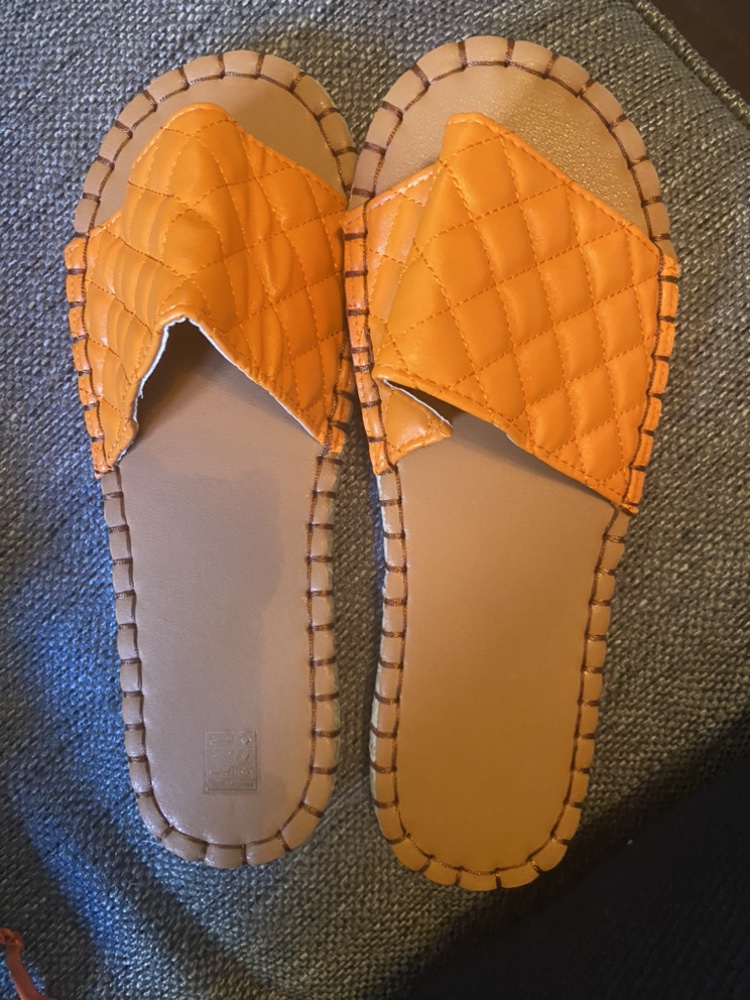 Orange quilted slip-on sandals