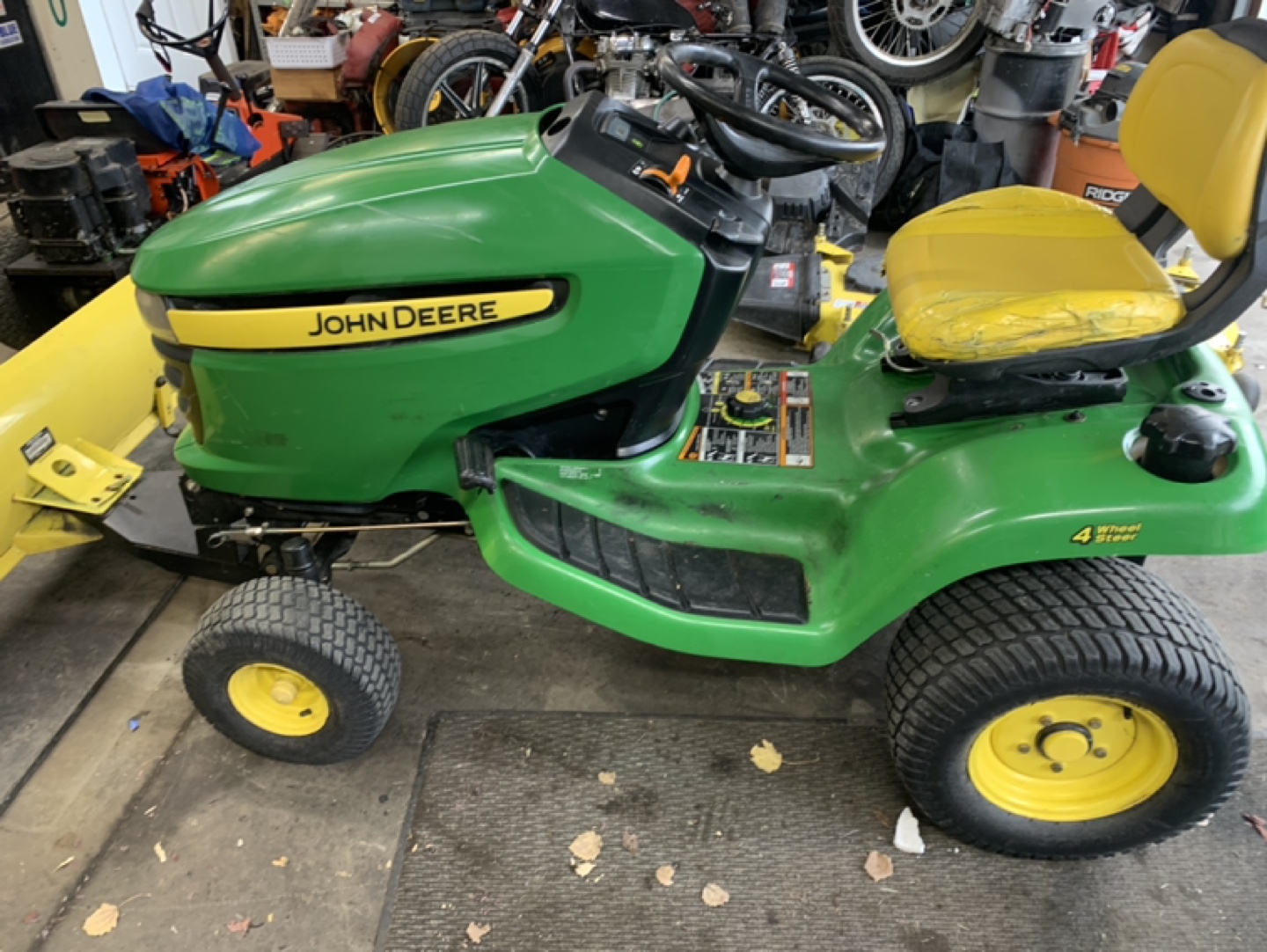 John Deere 324X all wheel steer, plus snow blade and chains - photo 2