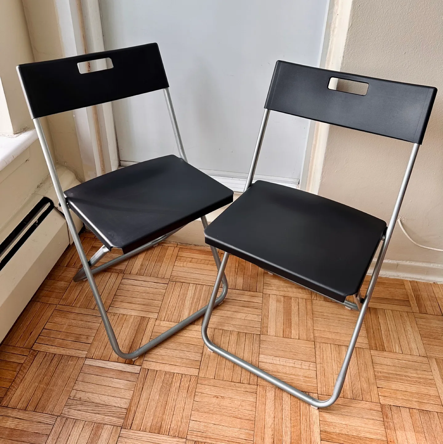 2 Black Plastic Folding Chairs thumbnail
