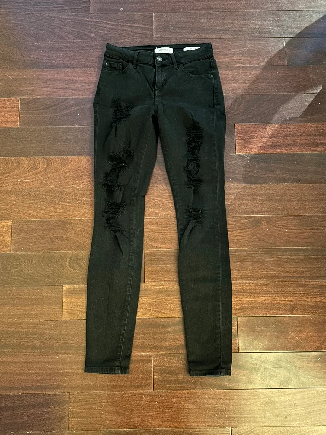 Guess women’s black ripped skinny jeans image indicator(3)