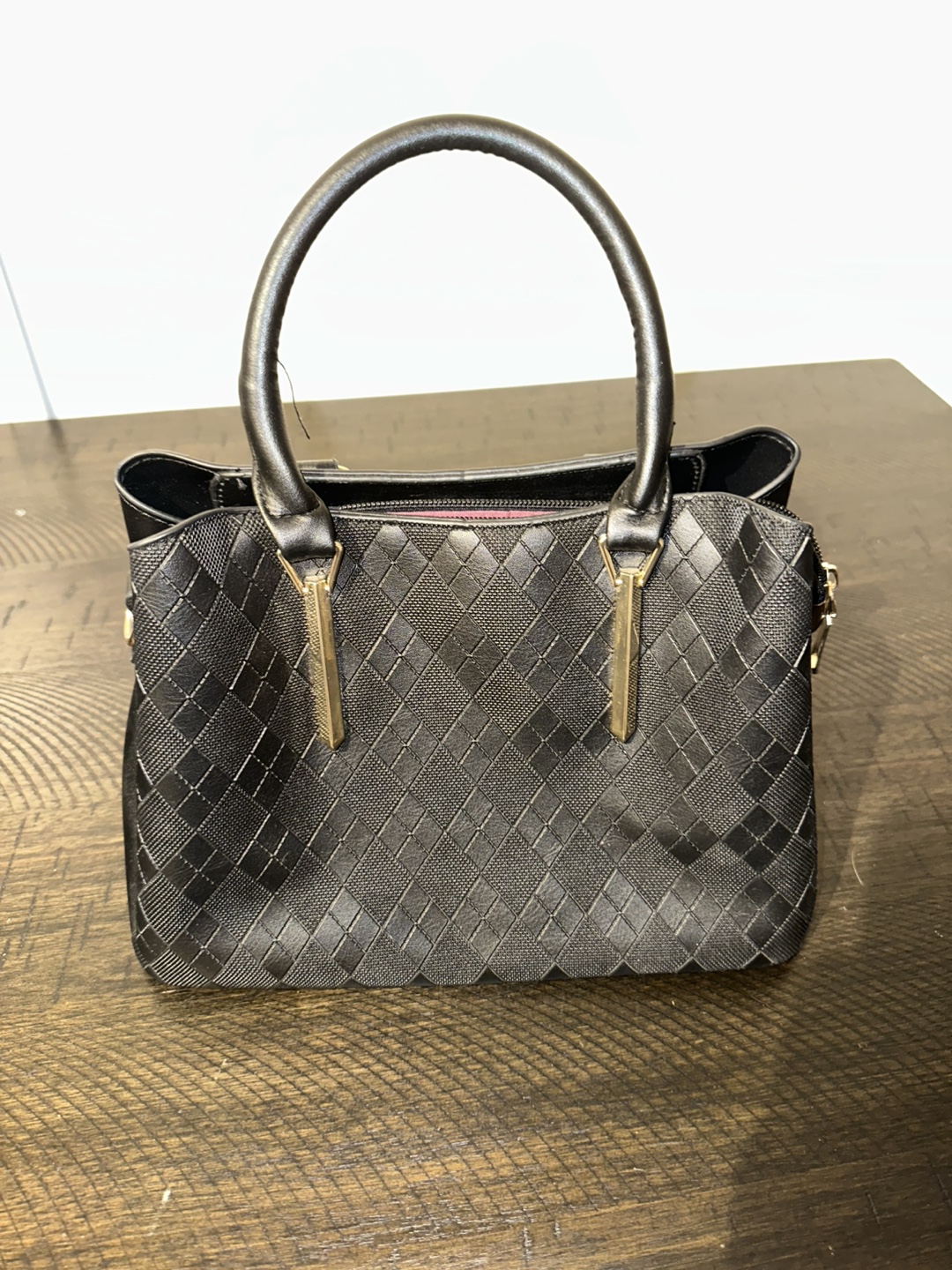 Black handbag with gold hardware