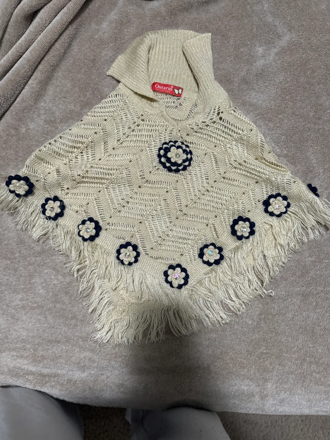 Cream knitted poncho with flower embellishments thumbnail