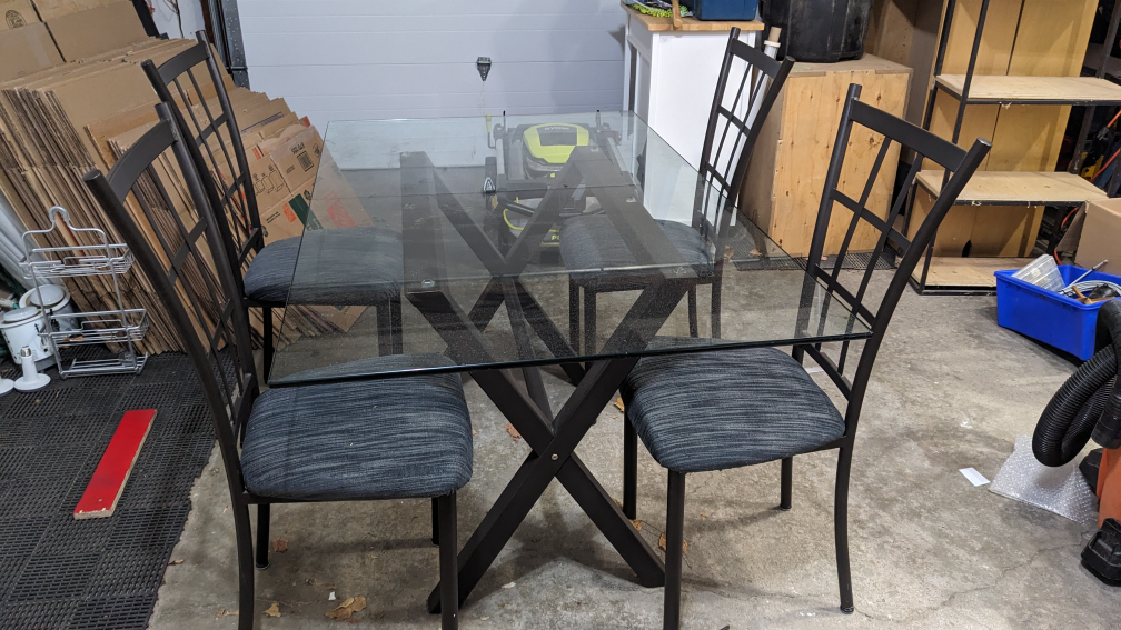 Glass dining table with four chairs