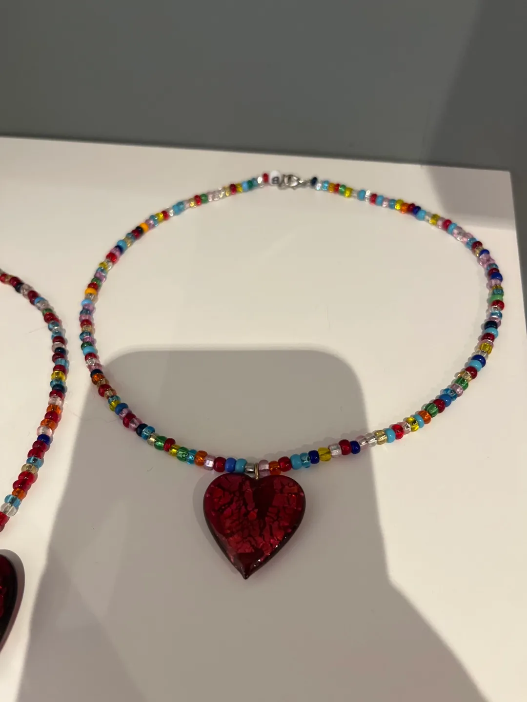2 Multicoloured Bead Necklaces with Red Heart Charm image indicator(3)