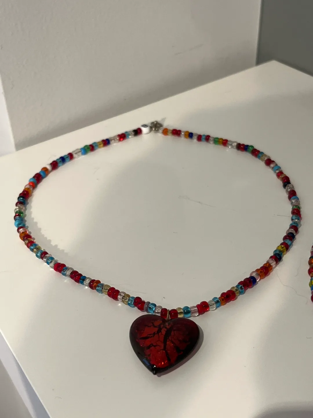2 Multicoloured Bead Necklaces with Red Heart Charm image indicator(2)