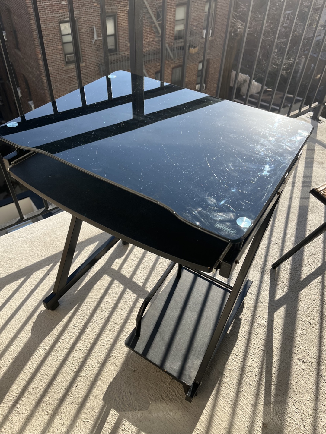 Black Glass Computer Desk with Rolling Bottom Shelf