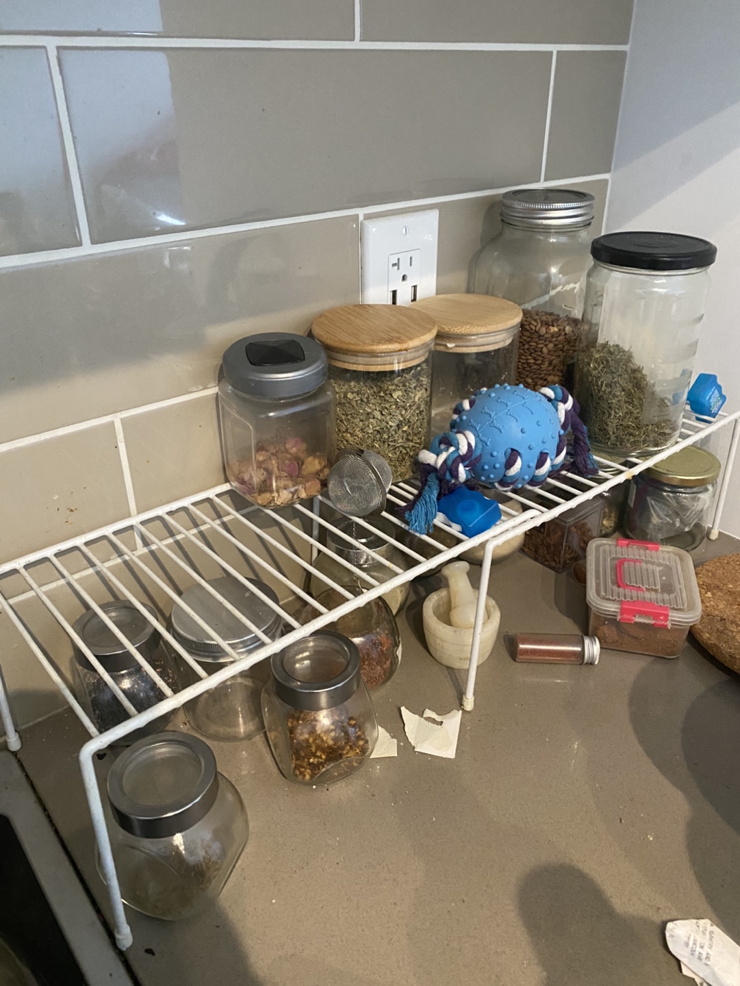 White Metal Spice Rack and variety of spices and spice jars