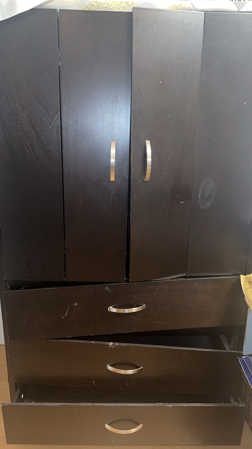 Dark brown wooden armoire with 3 drawers and a hanging rack