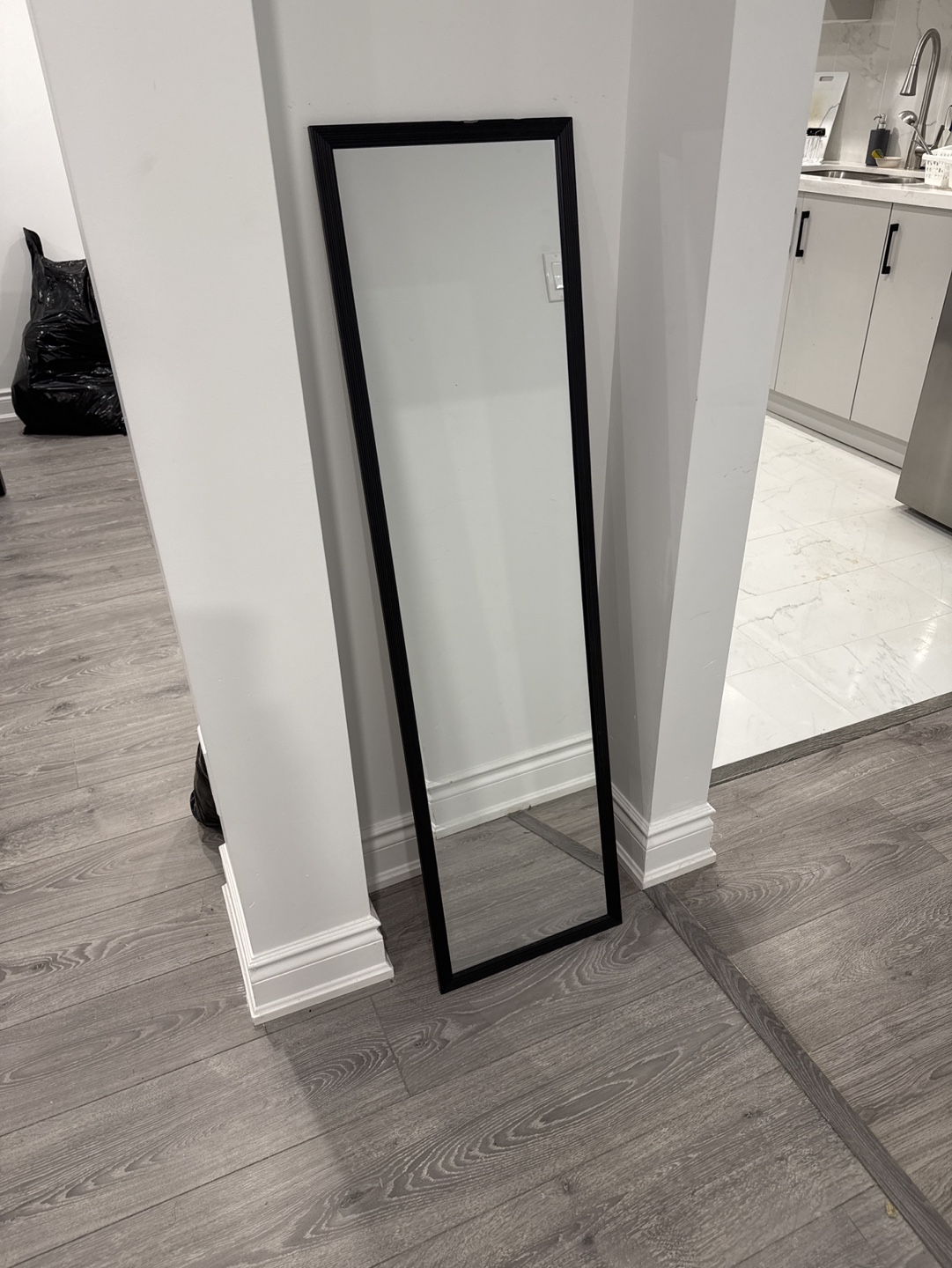 Full-length mirror with black frame