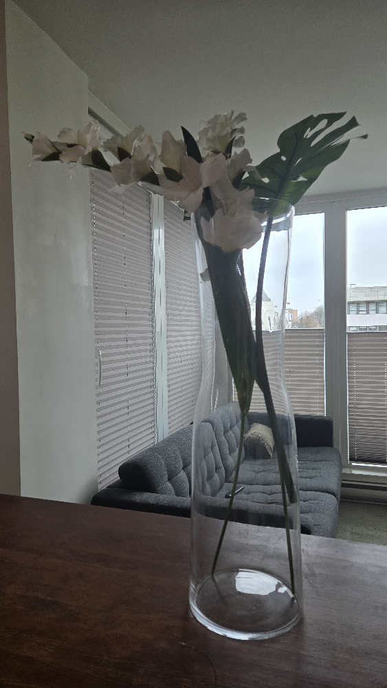 Tall glass vase with flowers