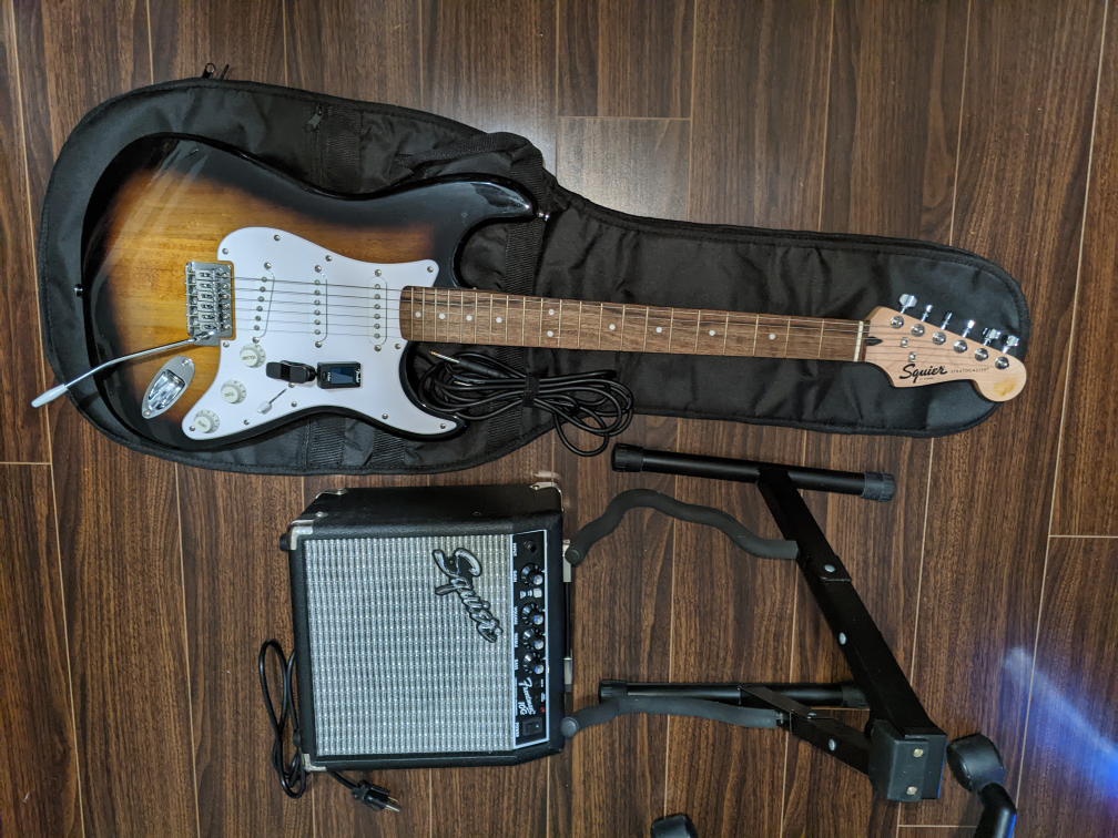 Squier by Fender Stratocaster Electric Guitar with Amp and Stand
