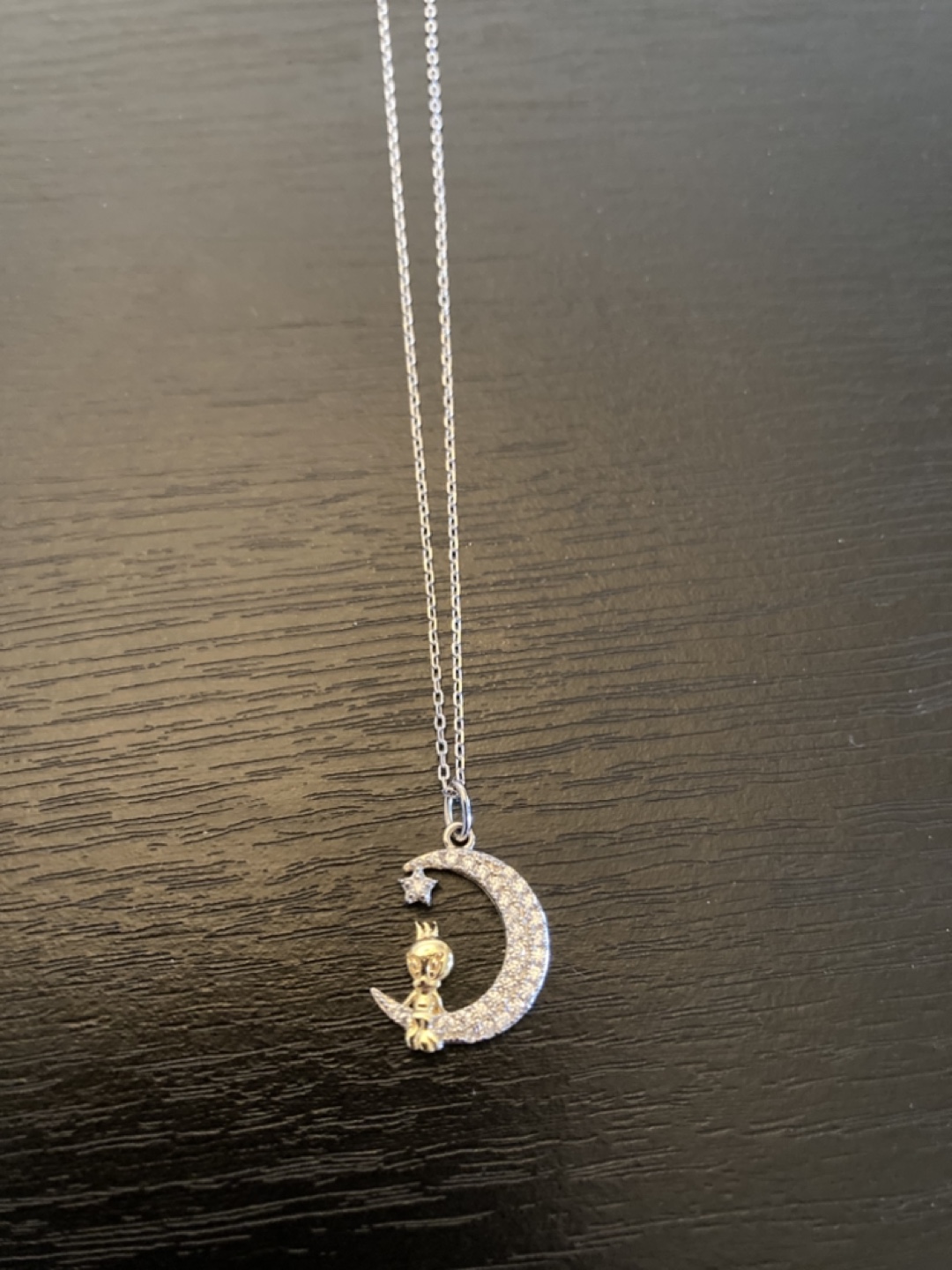 Sterling silver tweety bird sitting on a crescent moon