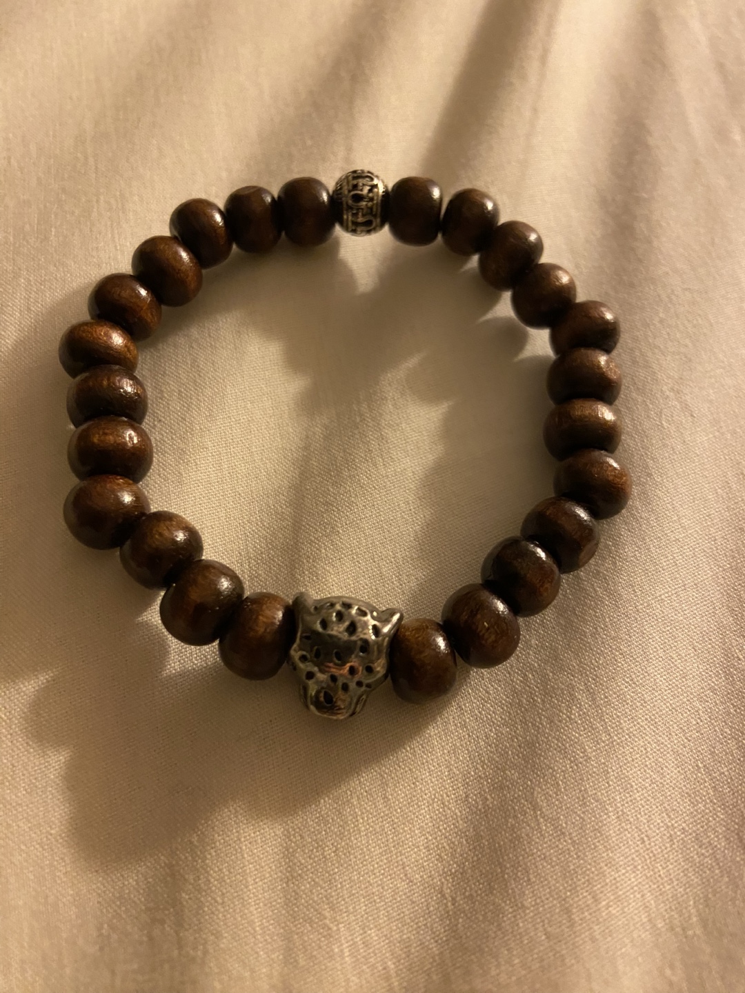 Wooden beaded bracelet with silver charm