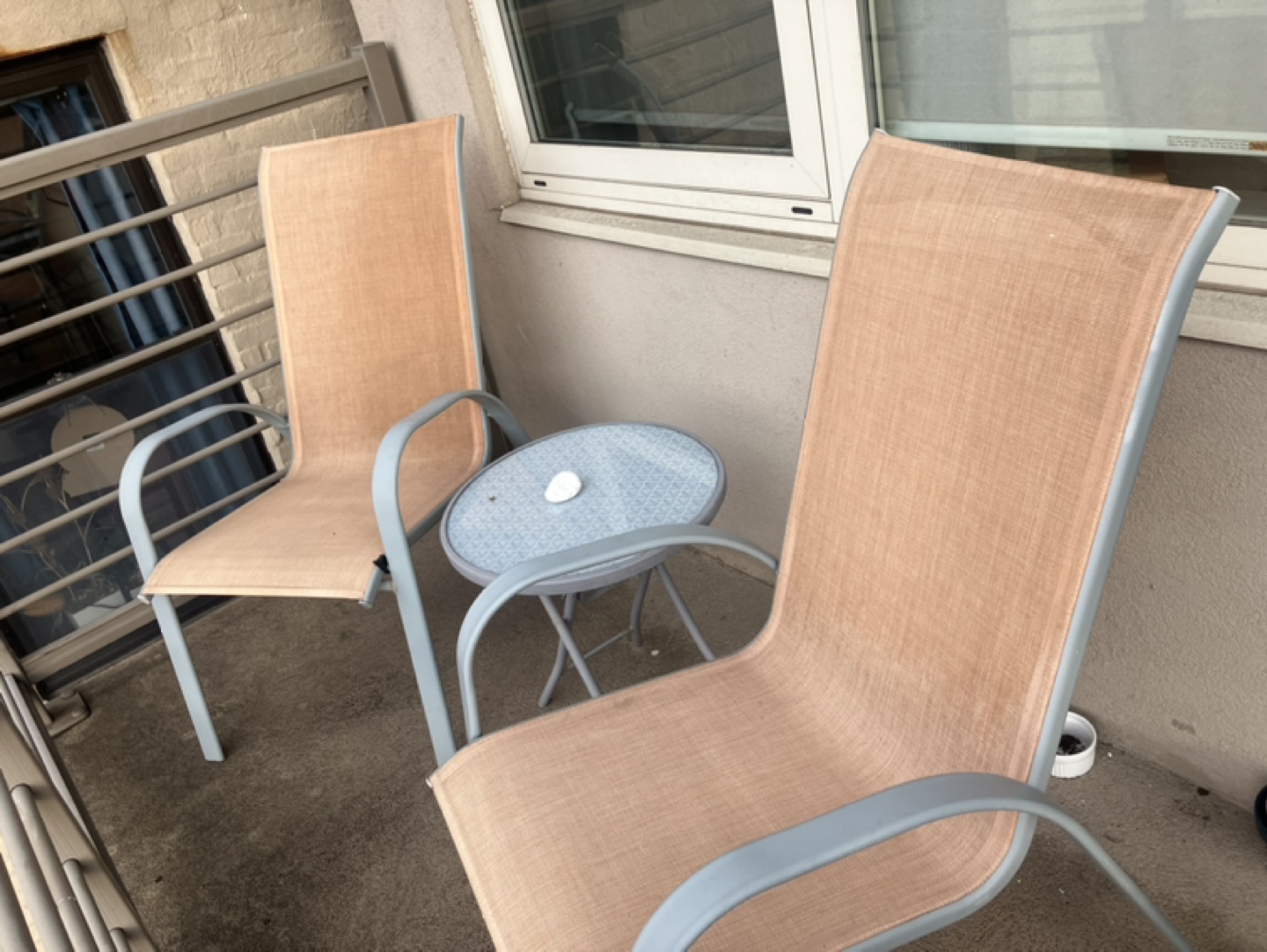 Two Beige Sling Patio Chairs with Small Table