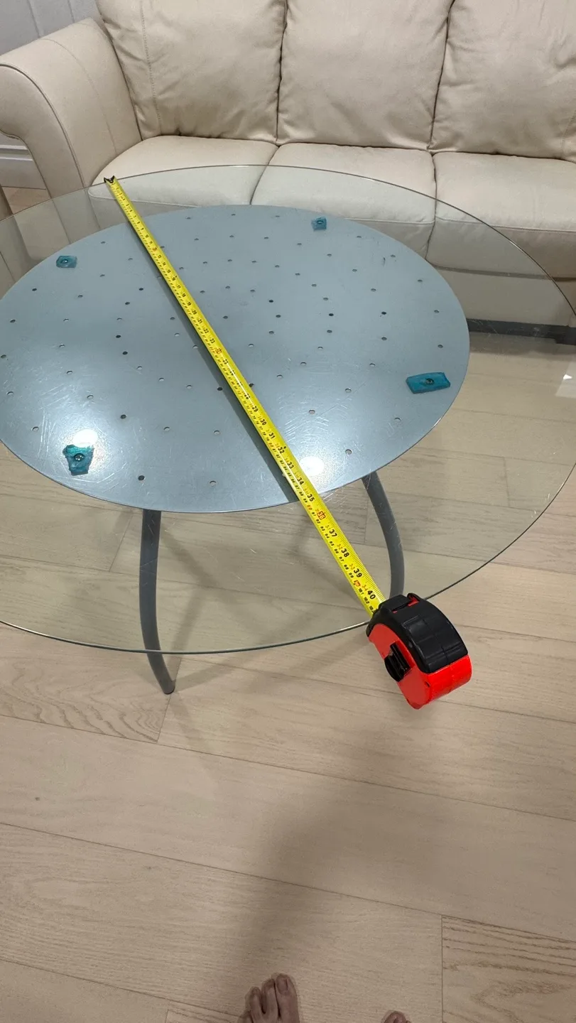 Glass top coffee table with unique curved metal legs image indicator(6)