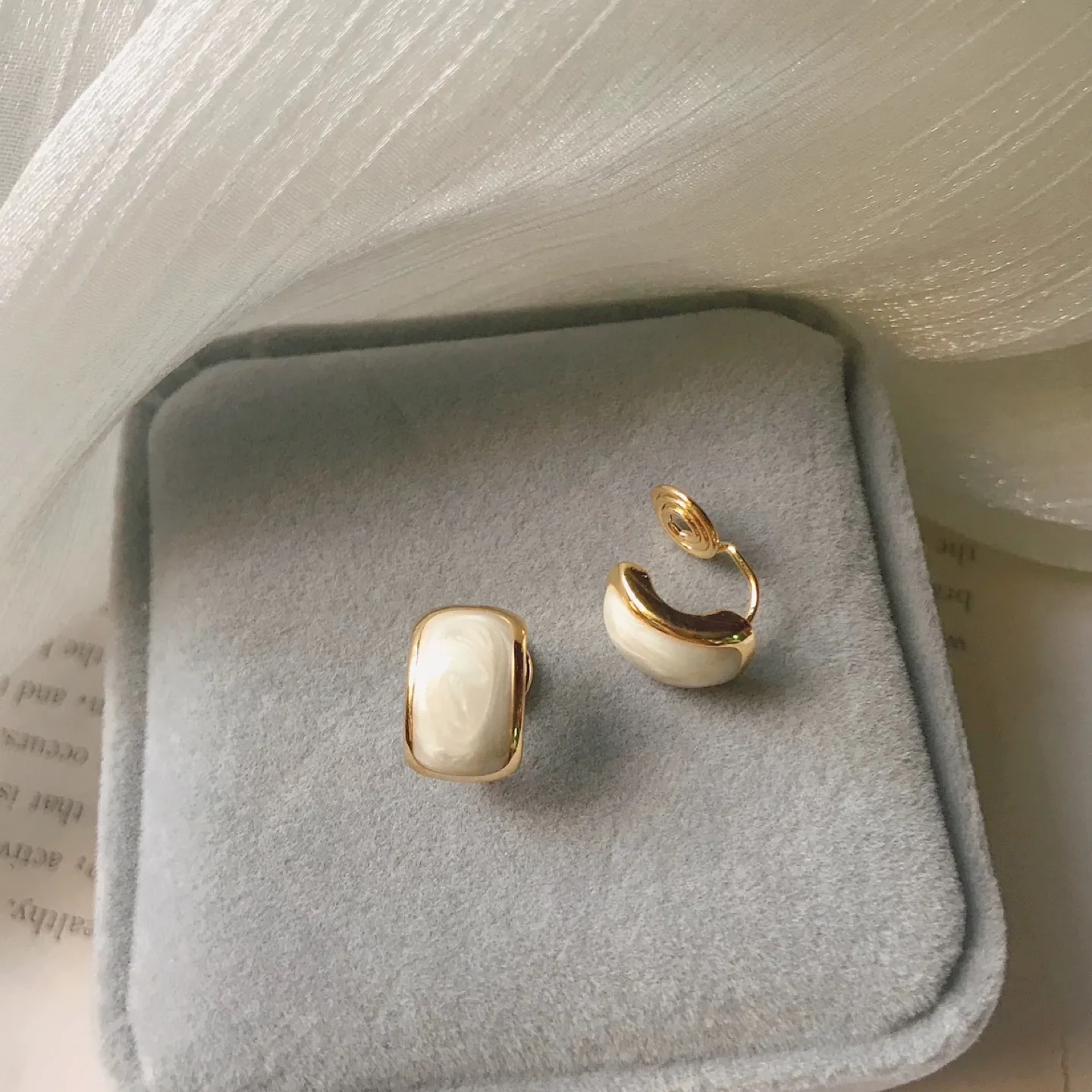Elegant Gold Clip-on Earrings with White Resin Detail thumbnail