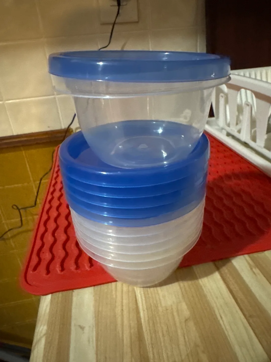 Stack of Clear Plastic Food Containers with Blue Lids thumbnail