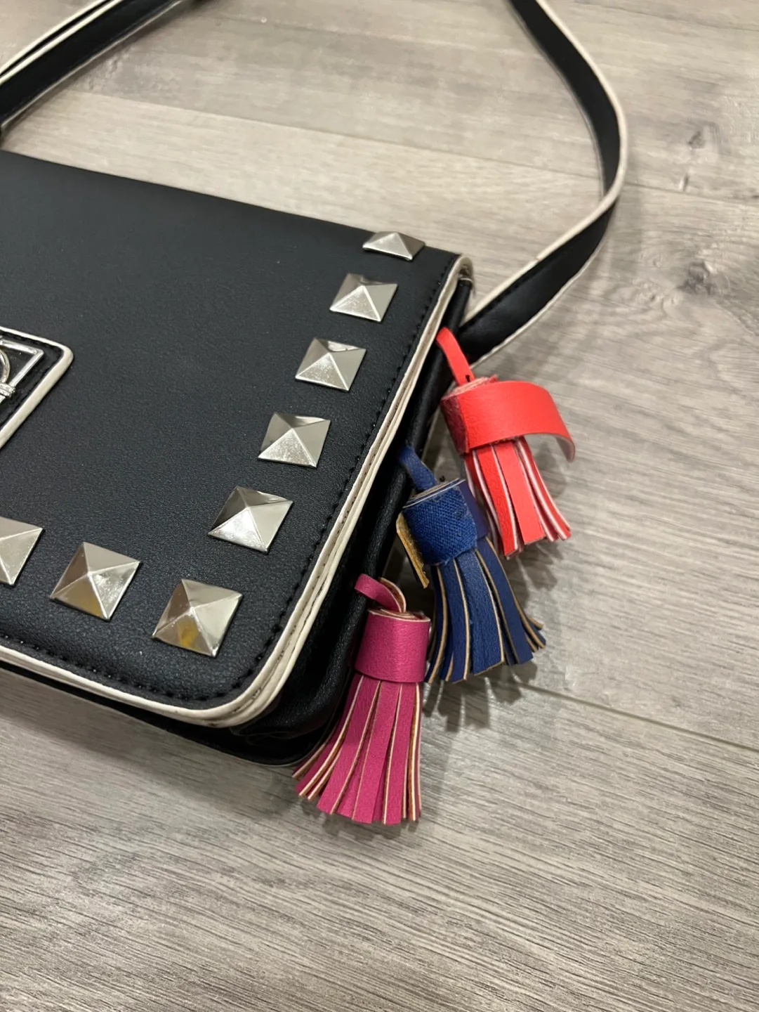 Black studded crossbody bag with colourful tassels image indicator(3)