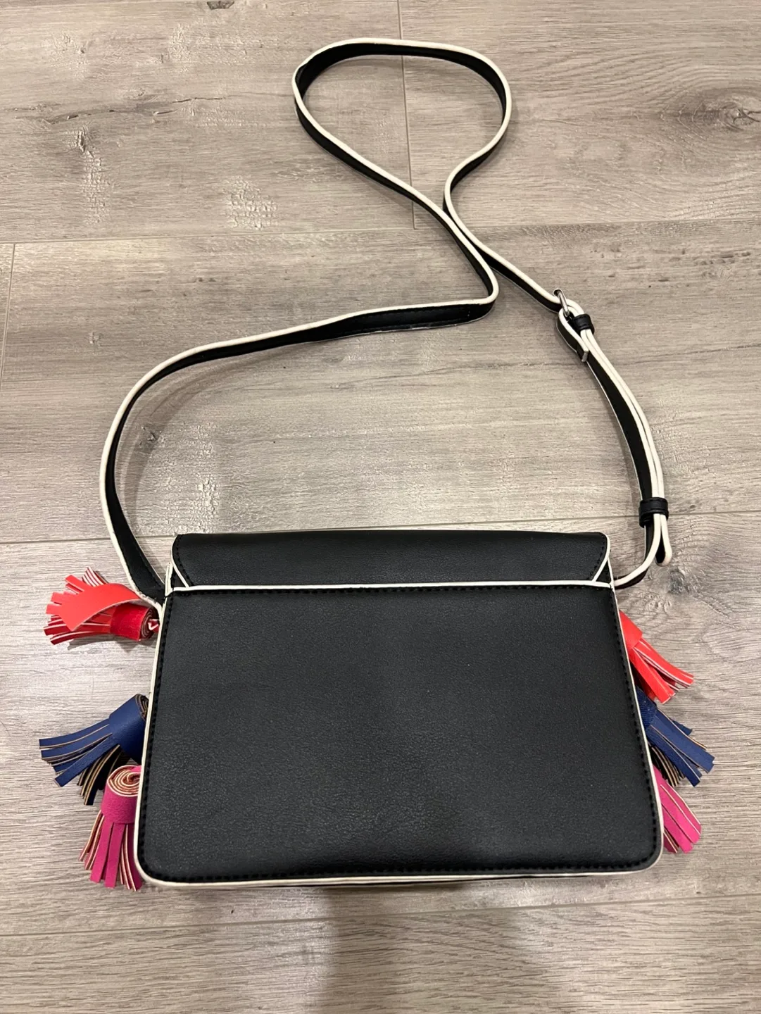 Black studded crossbody bag with colourful tassels image indicator(10)