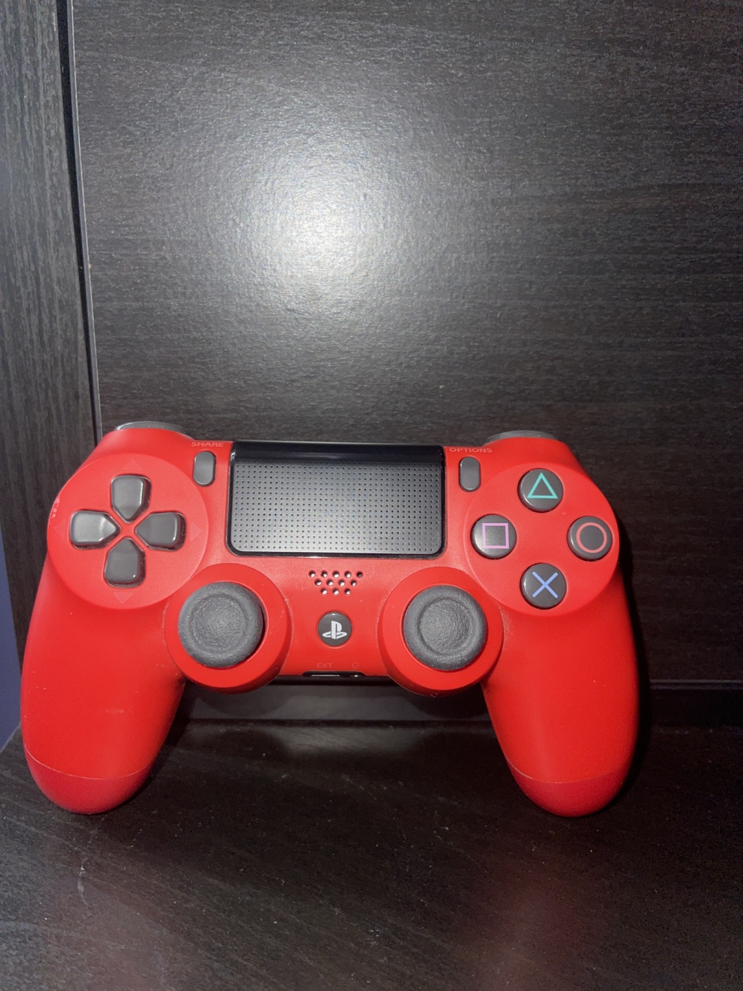 Two PlayStation 4 Controllers - Red and Camo