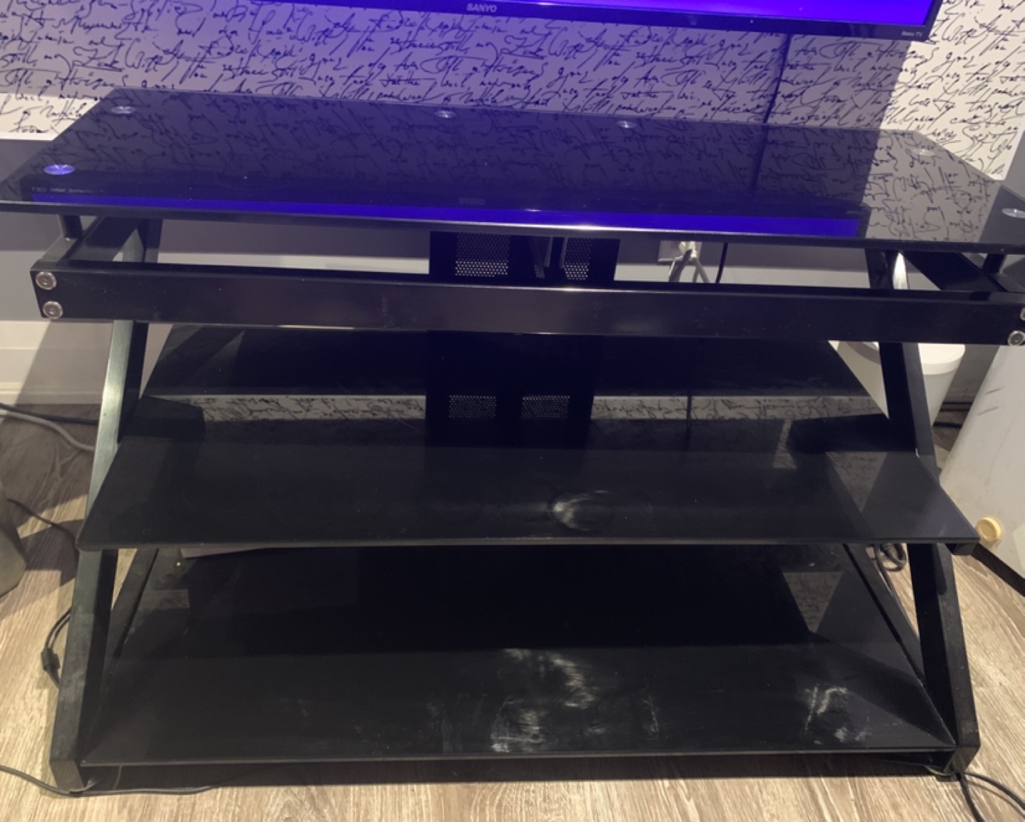 Sleek Black Three-Tier Glass TV Stand