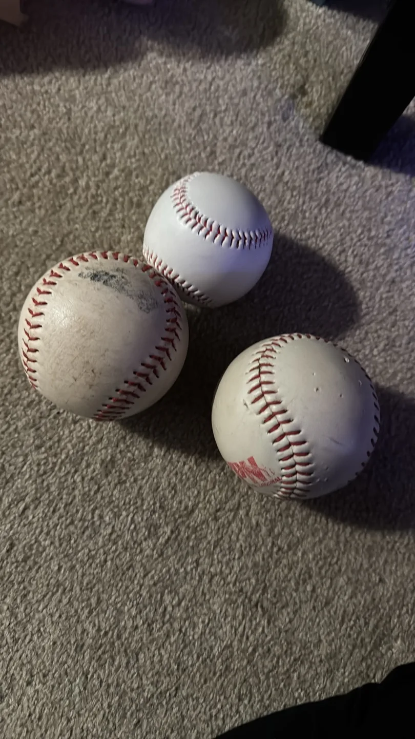Two baseball gloves and three baseballs image indicator(2)