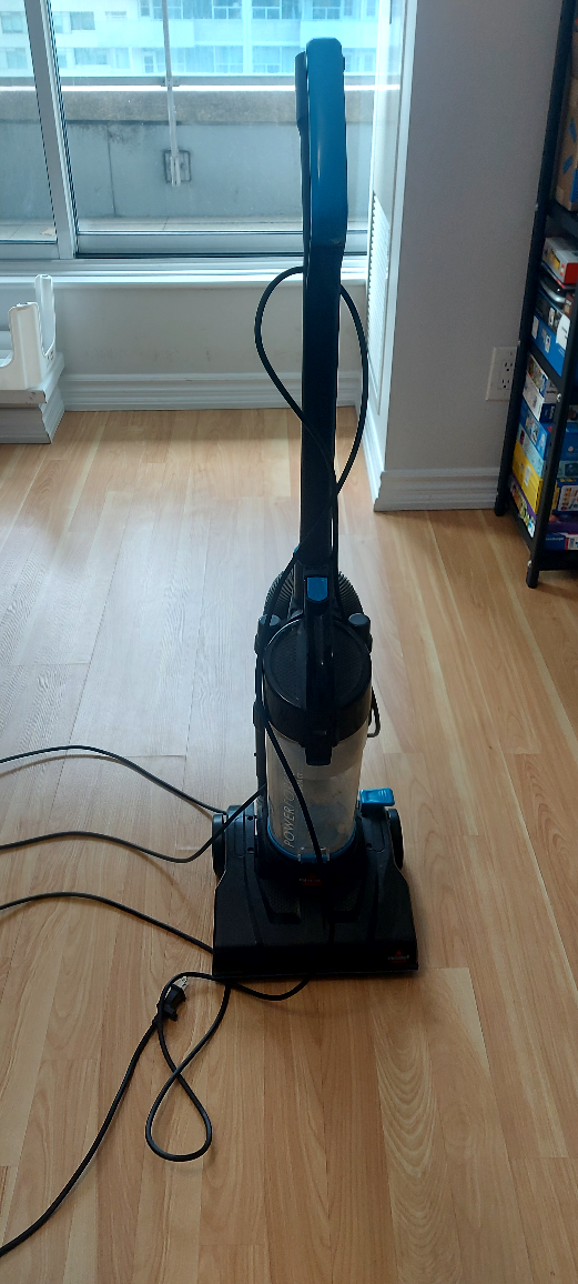 Used Black and Blue Upright Vacuum Cleaner