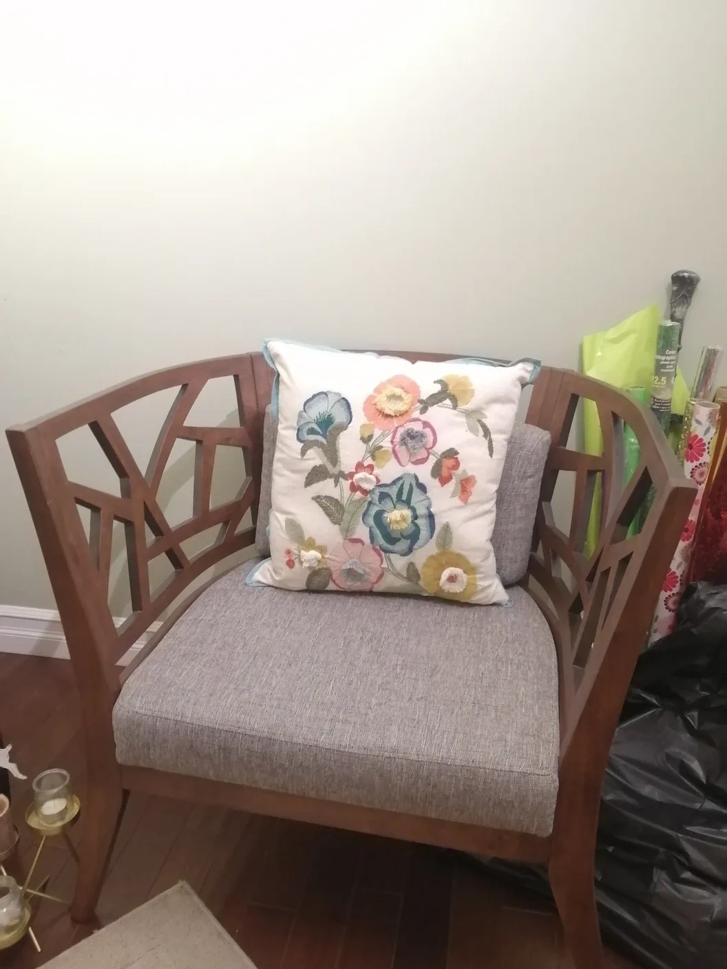 Wooden accent chair with floral pillow thumbnail