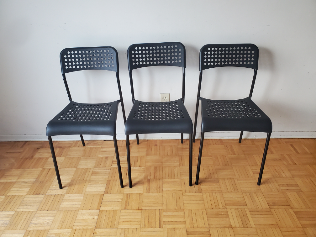 Three Black Plastic Chairs