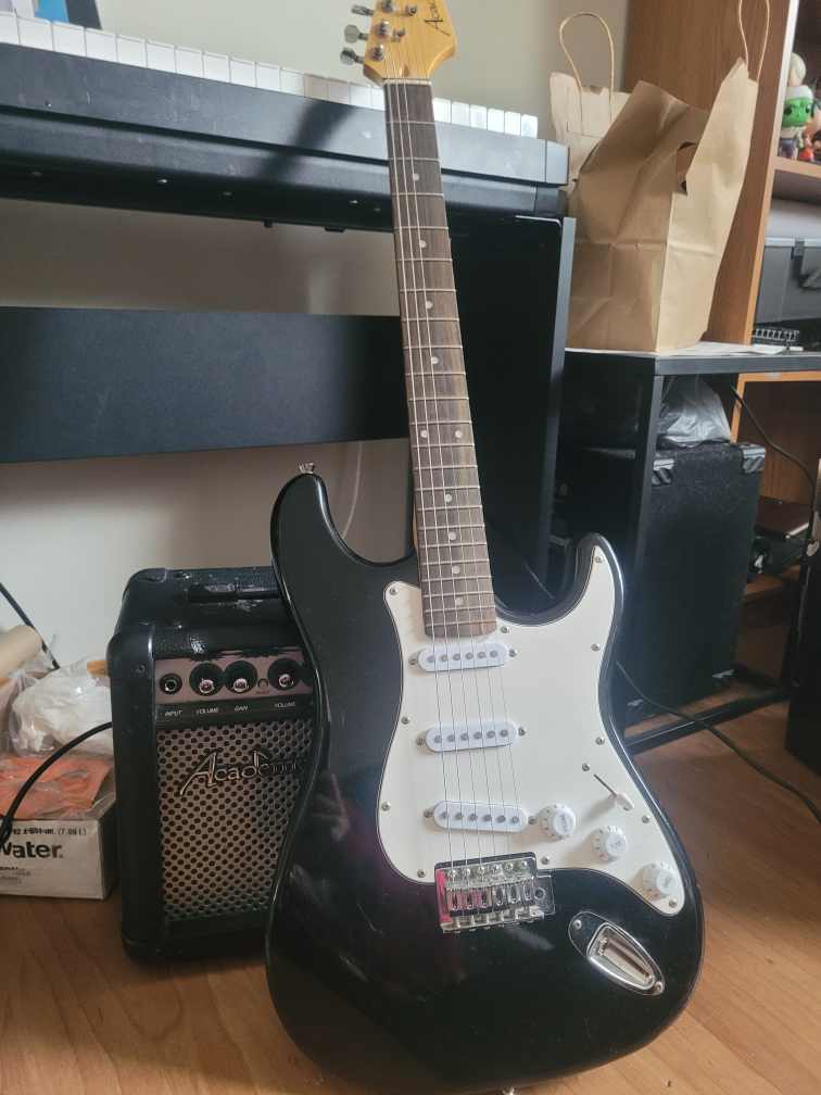 Black Electric Guitar with Amp