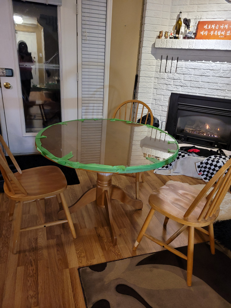 Glass-top dining table with four chairs