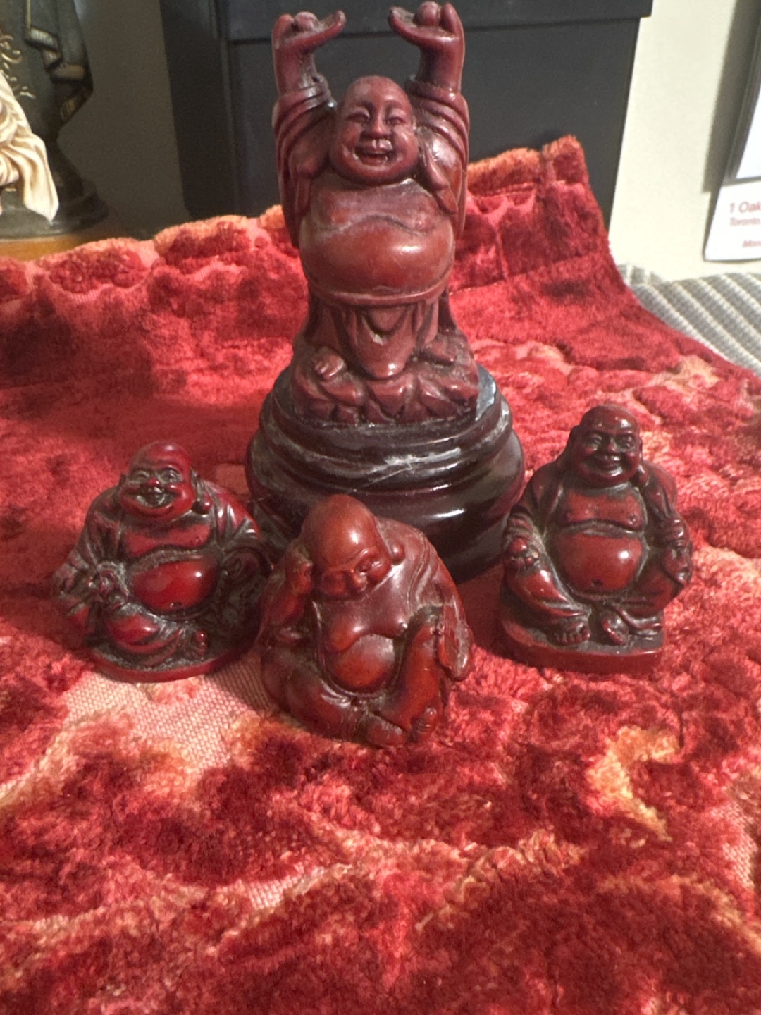 Set of four Laughing Buddha figurines