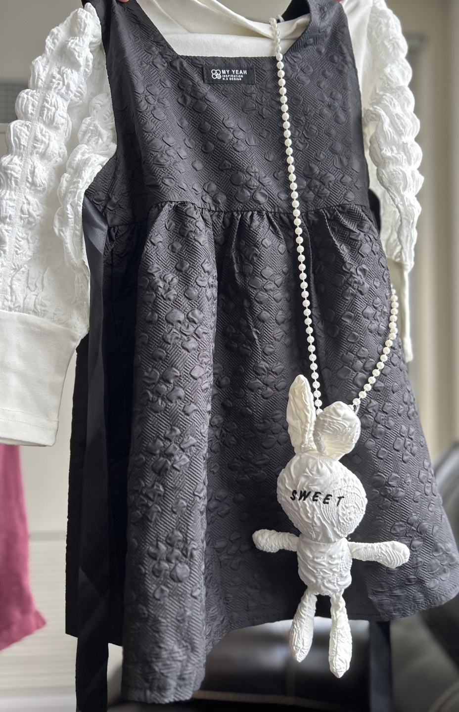 Black textured dress with bunny bag