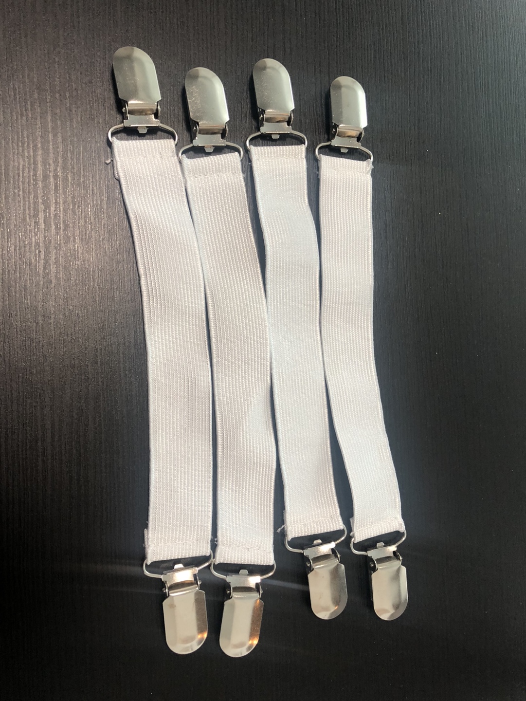 Four White Elastic Fabric Grippers with Metal Clips