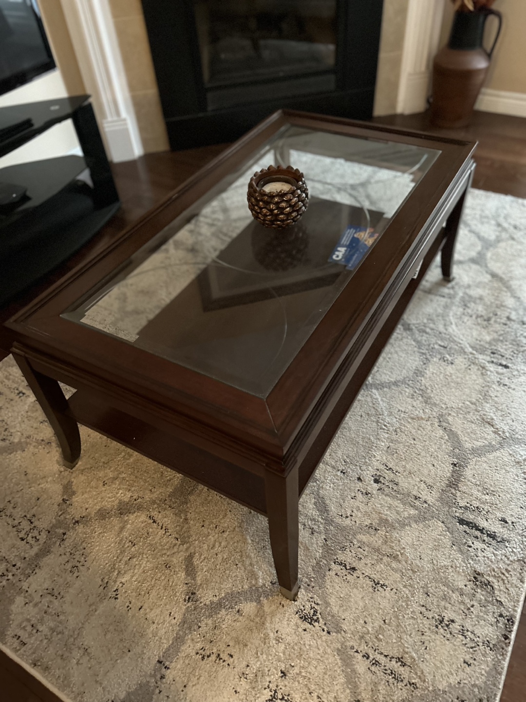 Dark brown wood coffee table with glass top