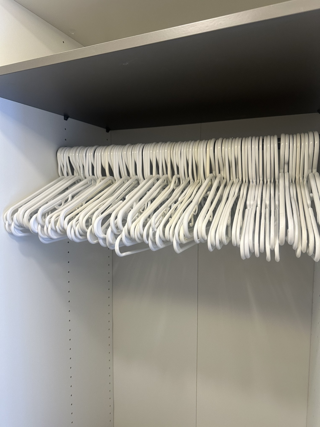 Bulk lot of white plastic hangers