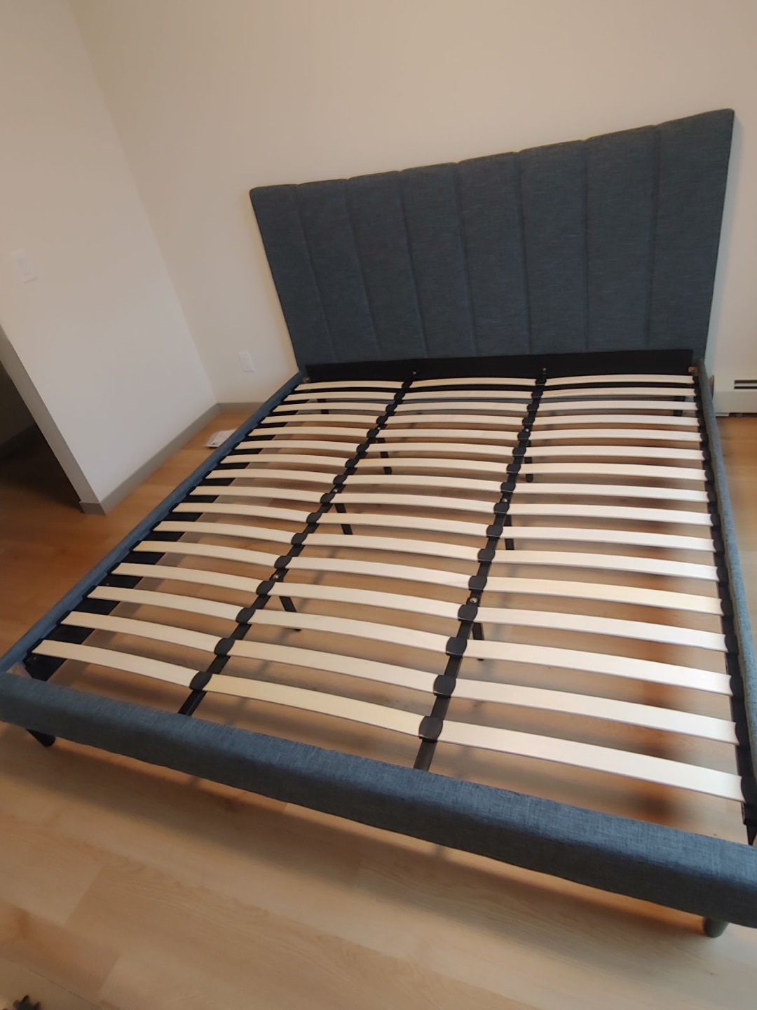 King-size upholstered bed frame with slatted base with mattress