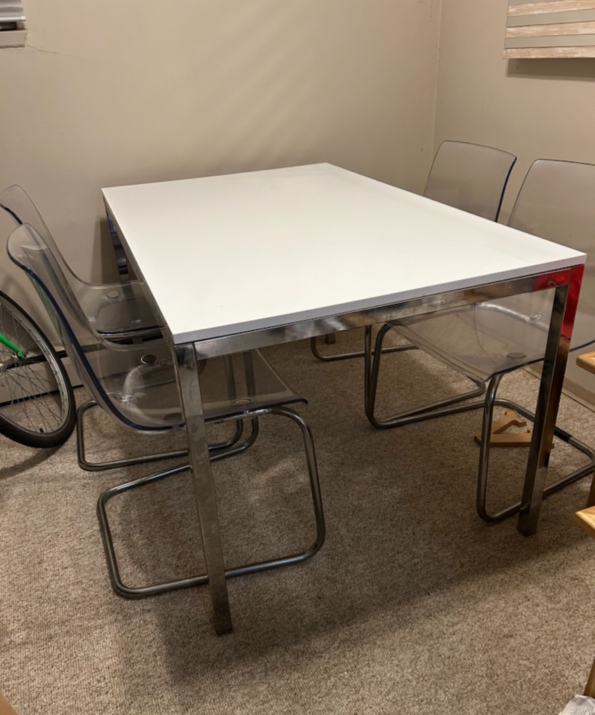 Dining Table with Chrome Legs and Four Transparent Chairs
