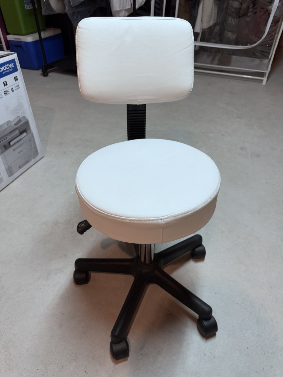 White rolling salon stool