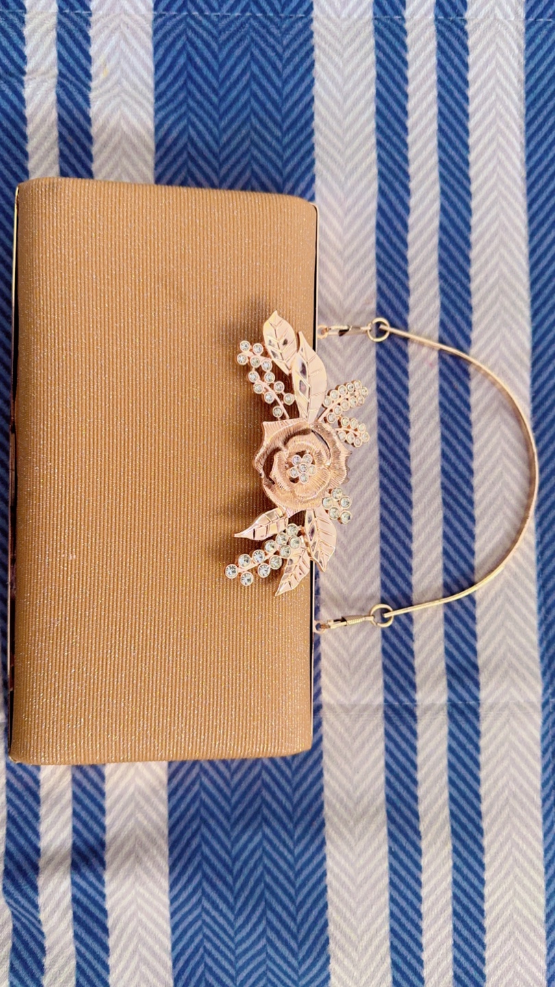 Gold sparkly clutch purse with rose embellishment