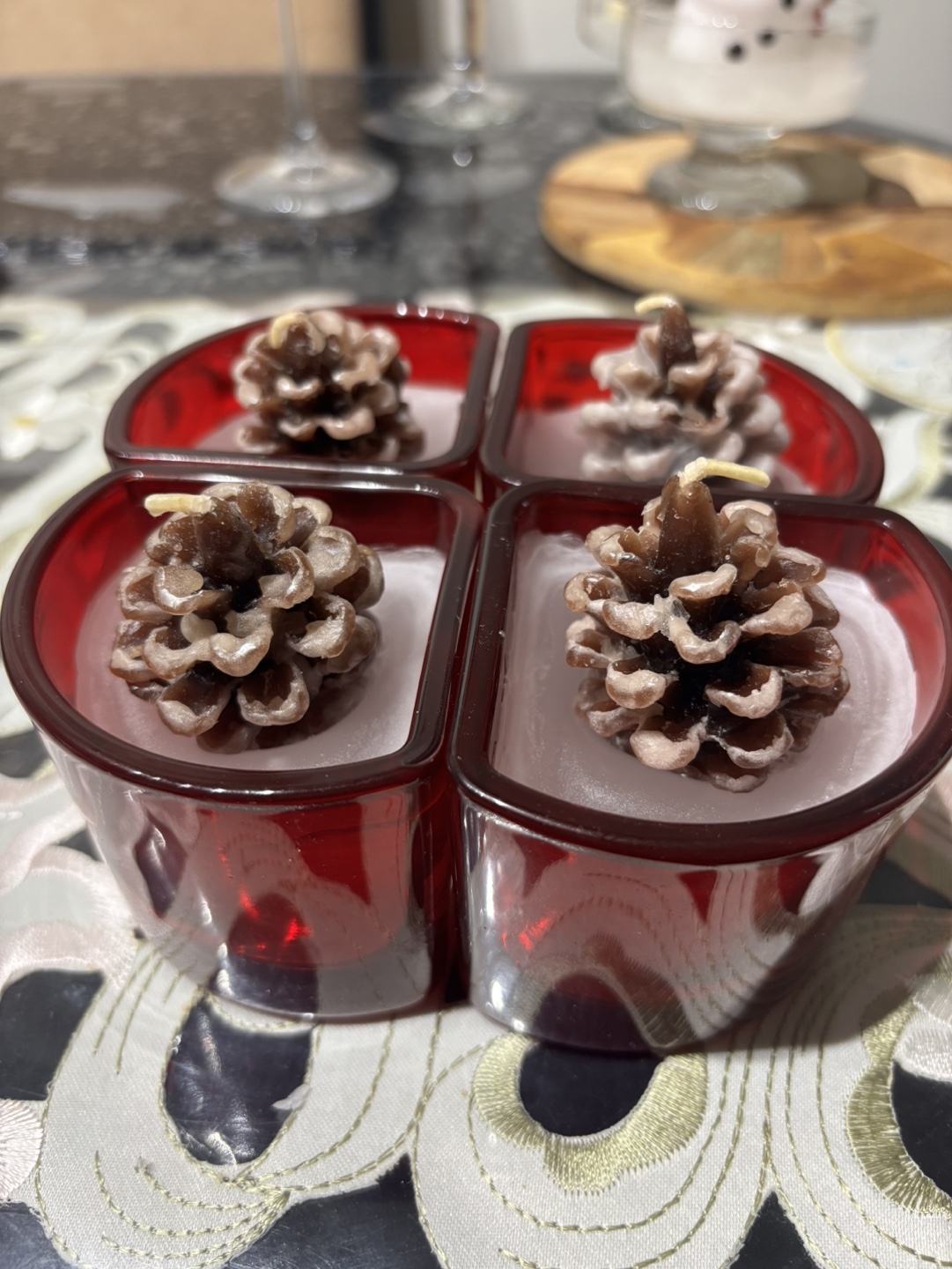 Set of Four Pine Cone Candles in Red Glass Holders
