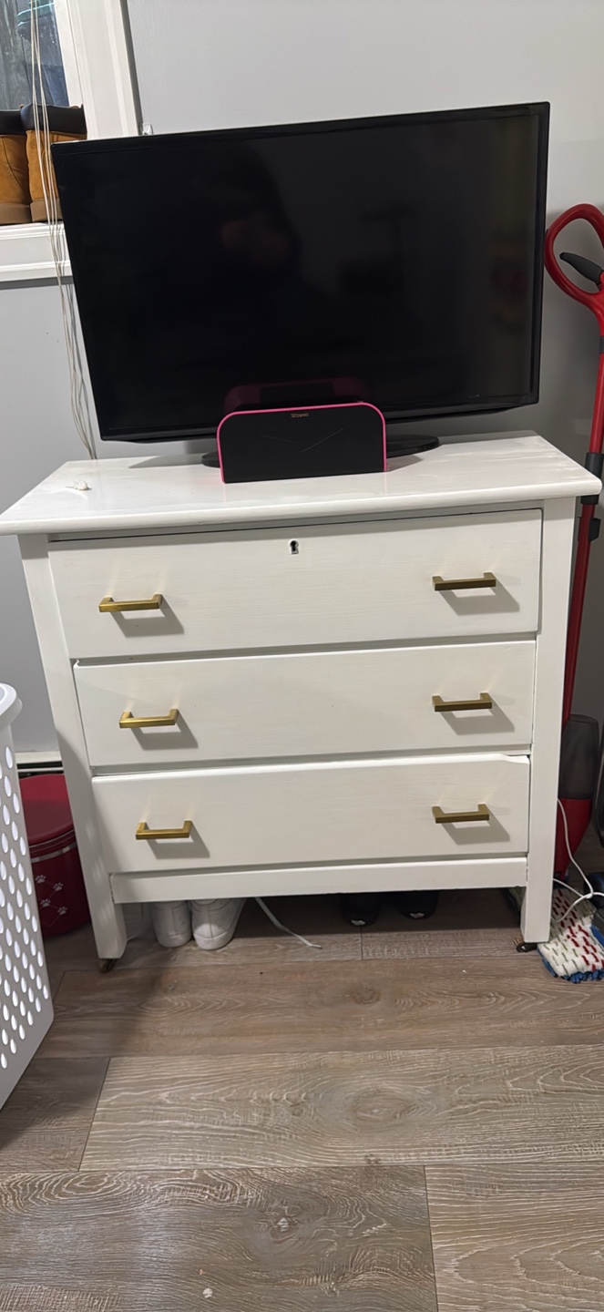 White dresser with gold knobs