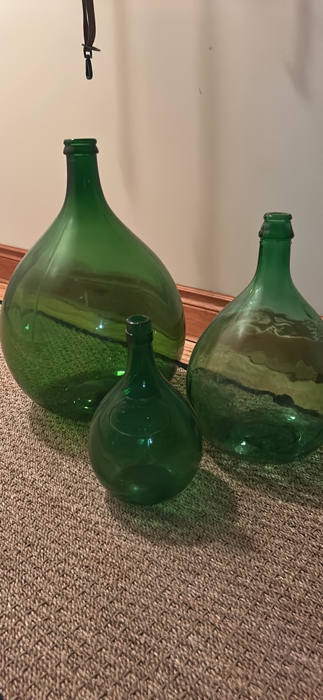 Set of three vintage green glass bottles